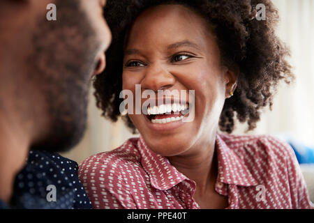 Couple Chatting And Relaxing On Sofa At Home Together Stock Photo