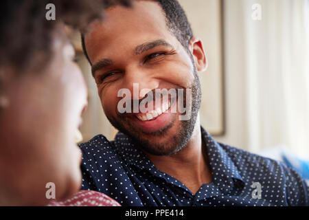 Couple Chatting And Relaxing On Sofa At Home Together Stock Photo