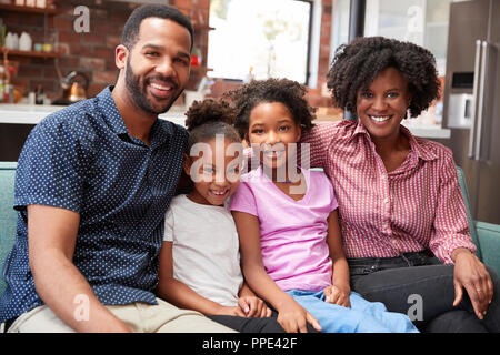 Portrait Of Family Relaxing On Sofa At Home Together Stock Photo