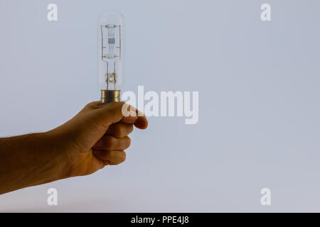 Large old radio valve being held in hand on white background Stock Photo