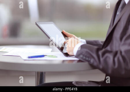 close up. businessman tapping the screen of digital tablet Stock Photo