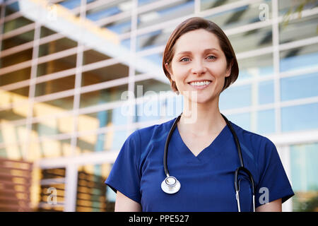 Smiling white female healthcare worker outdoors, portrait Stock Photo