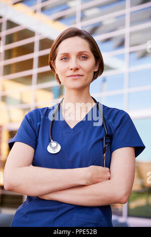 Smiling white female healthcare worker outdoors, vertical Stock Photo