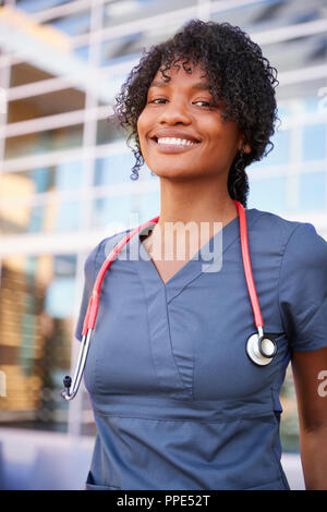 Smiling black female healthcare worker outdoors, vertical Stock Photo