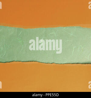 background .orange torn paper on white cardstock Stock Photo