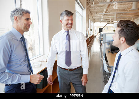 Three male business colleagues talking at work, close up Stock Photo