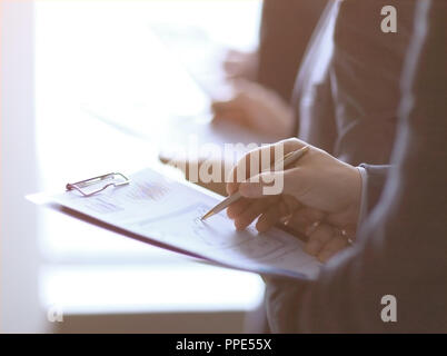 close up.businessman with clipboard checking statistics. business partners in the office Stock Photo