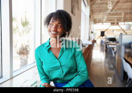 Young black female architect looking out of office window Stock Photo