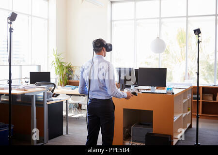 Businessman using VR technology in an office, back view Stock Photo