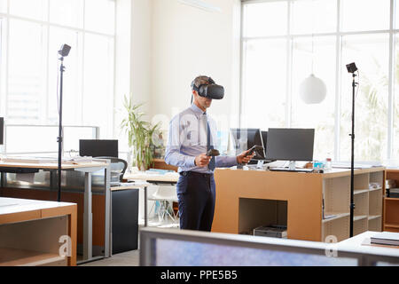 Businessman using VR technology in an office, side view Stock Photo