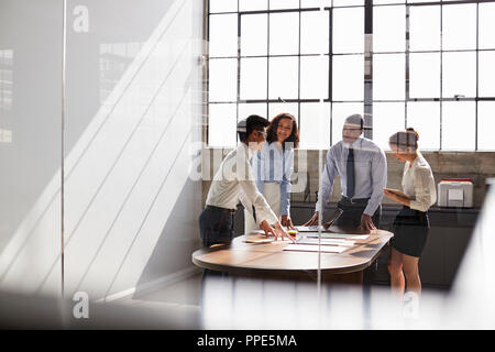 Business team seen through window working together in office Stock Photo