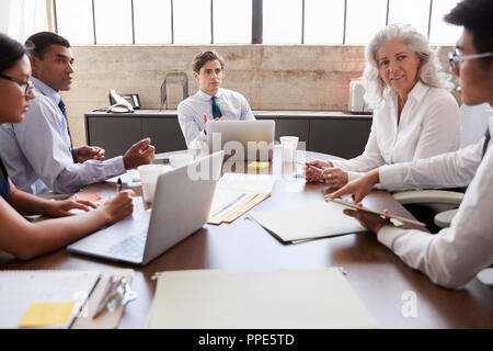 Business colleagues in discussion at a meeting Stock Photo