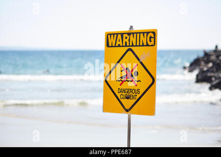 Warning, dangerous current sign on a beach in Queensland Australia Stock Photo