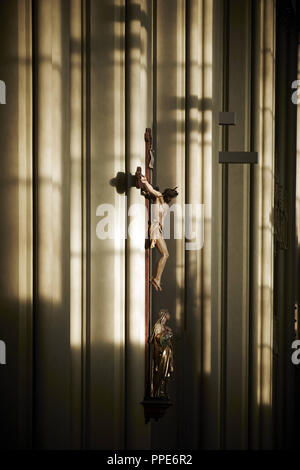 The renovated neo-gothic Heilig-Kreuz-Kirche (Church of the Holy Cross) in Giesing. Interior. Nave - early baroque crucifix from the old church. Stock Photo