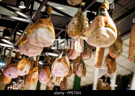 The Italian company Eataly opens a branch in the newly reconstructed Schrannenhalle in Munich. Here air-dried ham hanging from the ceiling. Stock Photo