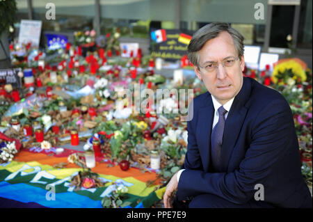 The French Consul General Jean-Claude Brunet, mourns the victims of the terrorist attacks in Paris. In the background, residents of Munich laid flowers and candles before the consulate building in the Heimeranstrasse. Stock Photo