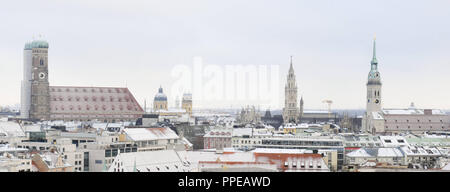 Panorama of the wintry city center of Munich with Frauenkirche, Theatine Church, Town Hall Tower and Alter Peter (Old Peter). Stock Photo