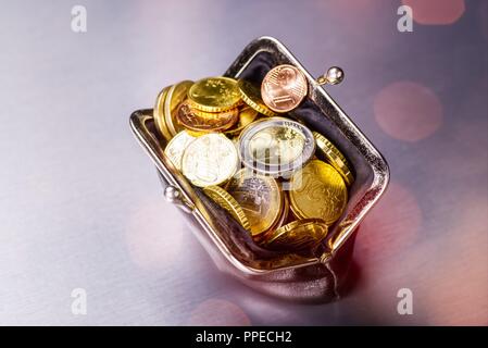 Wallet filled with many coins | usage worldwide Stock Photo