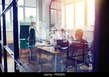 Working hard to win. Businesswoman conducting a business presentation using flipchart while working in the creative office. Stock Photo