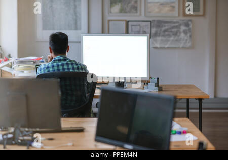 Designer working late on a computer in an office Stock Photo