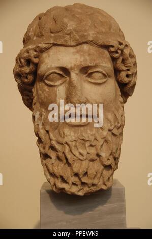 Head of a bearded god in Pentelic marble probably depicting Zeus or Hermes. It seems a work by parian sculptor Euphron. Dated between 450-440 B.C. Eetioneia sanctuary in Piraeus. National Archaeological Museum. Athens. Greece. Stock Photo