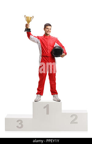 Full length portrait of a male racer winner on a winner's pedestal with a gold trophy cup isolated on white background Stock Photo