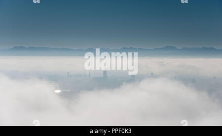 City silhouette of Munich in the fog, seen from the Olympiaturm. Stock Photo