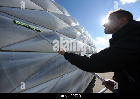 A man cleans the outer shell of the Allianz Arena in Munich, Germany Stock Photo