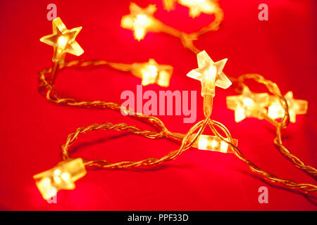 Star shaped Christmas light with blured lights in background, very shallow DOF Stock Photo