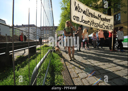 Residents demonstrate against the felling of trees on Josephsplatz, where a parking garage is to be built. The picture shows a banner with the inscription "We do not want the Monster on Josephsplatz". Stock Photo