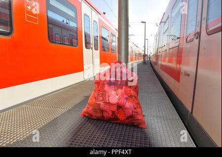 The cleaning personnel of Deutsche Bahn doing the daily cleaning of S-Bahn trains. The picture shows a garbage bag full of collected waste. Stock Photo