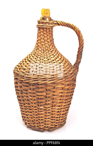 Old demijohn wicker wrapped glass bottle isolated on white Stock Photo