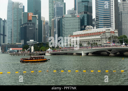 The Fullerton Hotel and Financial District Skyscrapers with Taxi River Boat and Tourists in Downtown Singapore Republic of Singapore Asia Stock Photo