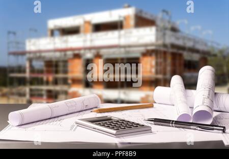 Construction plans with calculator and a shell in the background | usage worldwide Stock Photo
