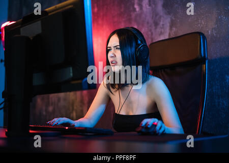 Portrait of a worried woman using a PC in the night at home. Stock Photo