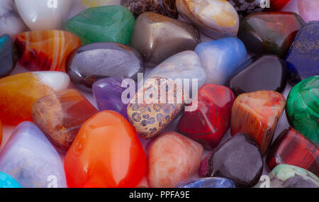 Close-up semi-precious stones background. Pileof polished gemstones. Stock Photo