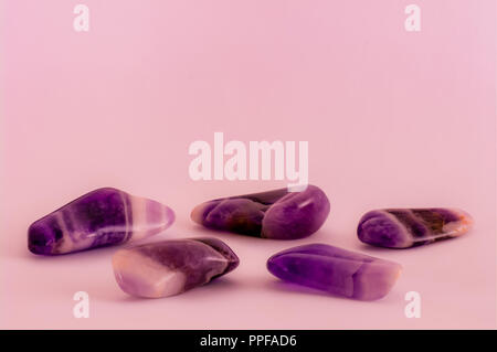 Polished dogtooth amethyst stones background with copy space Stock Photo