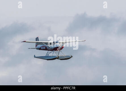 Seaplane or floatplane flying over Lake Hood Seaplane Base the world's busiest seaplane base located in Acnhorage Alaska Stock Photo