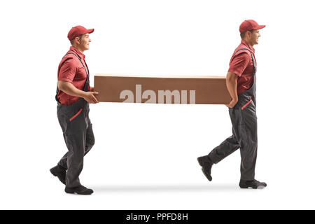 Full length profile shot of two movers carrying a big cardboard box isolated on white background Stock Photo