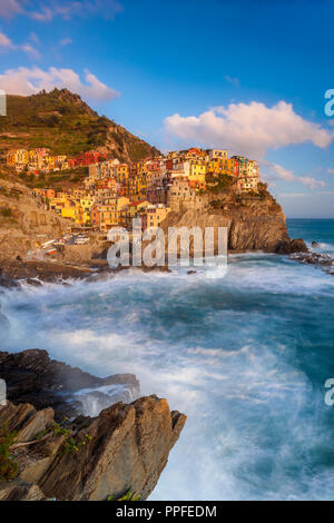 Swirling ocean at the foot of medieval town of Manarola in The Cinque Terre, Liguria Italy Stock Photo