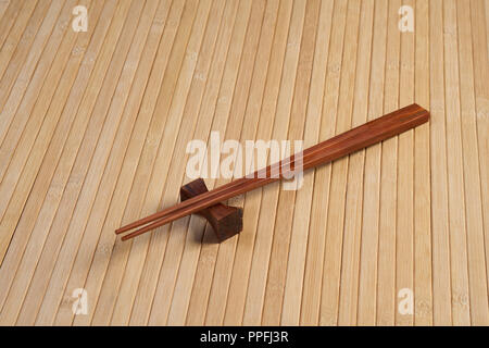 Beige bamboo napkin and a pair of chopsticks Stock Photo
