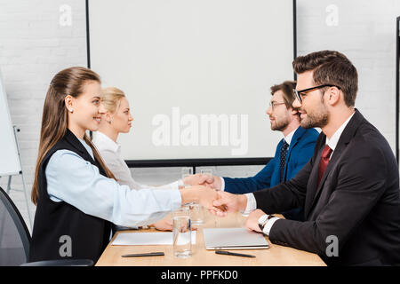 two teams of business people shaking hands during meeting at modern office Stock Photo