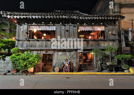 Cebu, Philippines-October 18, 2016: Filipino older lady sits at the entrance to her ancestral house in the Mabini and Lopez Jaena streets corner of th Stock Photo