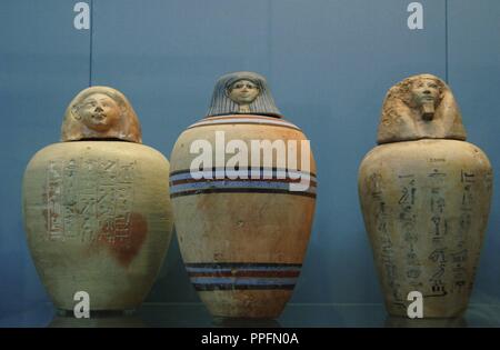 Polychormed canopic jars. Used by the egyptians during the mummification to preserve the viscera. On the left, painted jar of a child of the Royal Nursery of Ahmose. 1500 BC. From Upper Egypt. In the center, painted jar without inscription. 1450 BC. On the right, jar with hieroglyphic text. 1500 BC. Unknown origin. British Museum. London. United Kingdom. Stock Photo