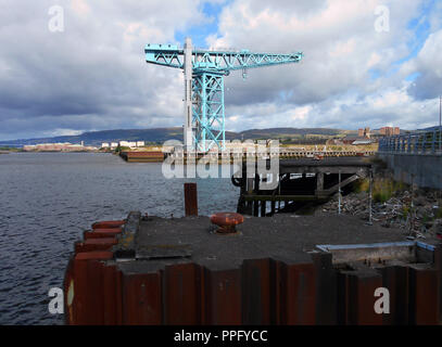 The mighty Titan crane stands, overlooking the River Clyde, on a quayside that was once part of the famous John Browns shipbuilding yard in Clydebank near Glasgow. The crane has now been renovated and is a very popular visitor and tourists attraction which allows stunning views from the jib of the crane. Stock Photo