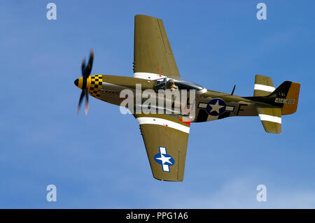 North American P-51 Mustang fighter plane named Janie restored and flown by Maurice Hammond. US Air Force airplane. Flying in blue sky Stock Photo