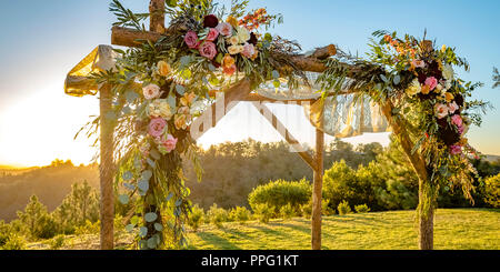 Vibrant flowers and sheer cloth on a Chuppah Stock Photo