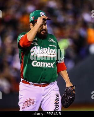 Edgar Gonzalez, starting pitcher of the Tomateros of Culiacan de Mexico, makes pitches in the first inning of the Caribbean Series baseball game again Stock Photo