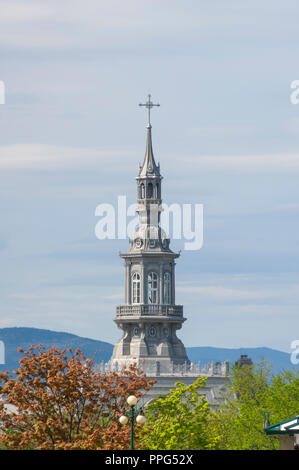 The ornamental steeple of the Camille-Roy Building (Séminaire de Québec) rising above tree canopies. Quebec City, Quebec, Canada Stock Photo