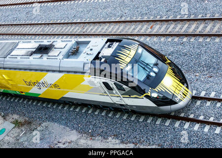 West Palm Beach Florida,Brightline passenger train overhead view from above engine passing Stock Photo